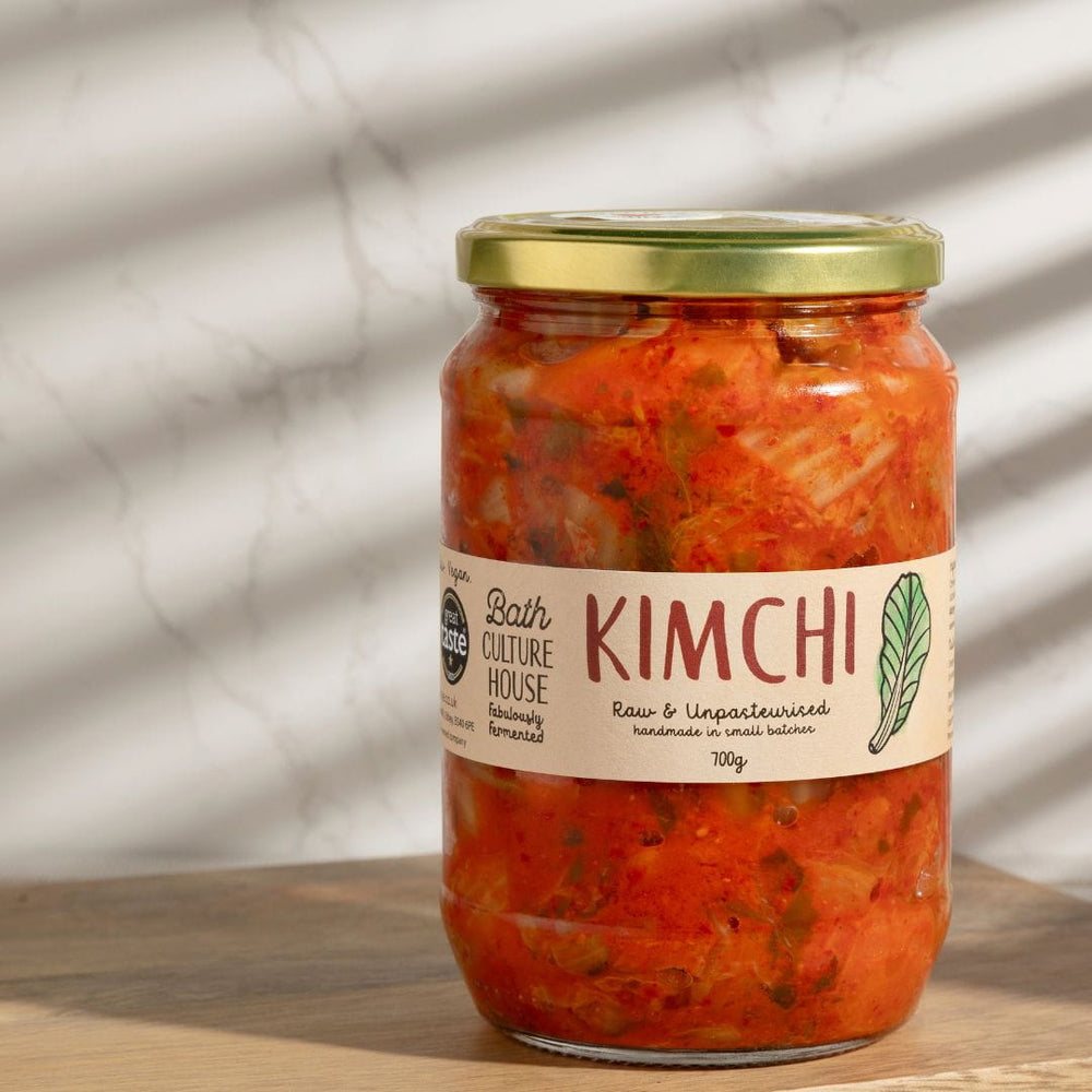 Big jar of kimchi with a label on a wooden surface