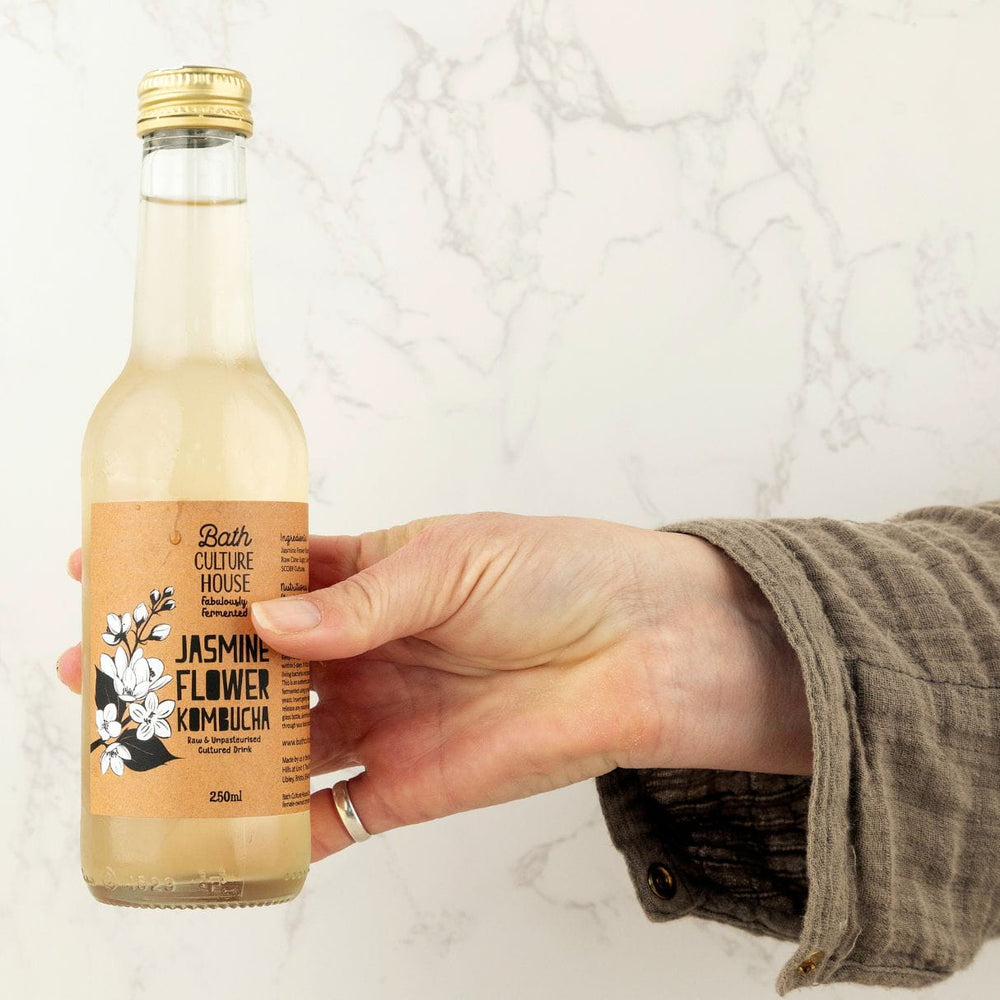 Bath Culture House Jasmine kombucha hand held. Contains live bacteria.